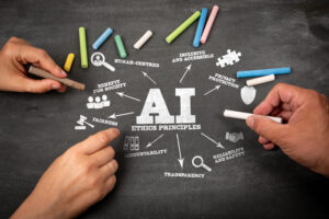 Hands holding chalk near «AI Ethical Principles» on a chalkboard, with related terms like fairness, accountability, privacy and the role of AI in business surrounding the central text.